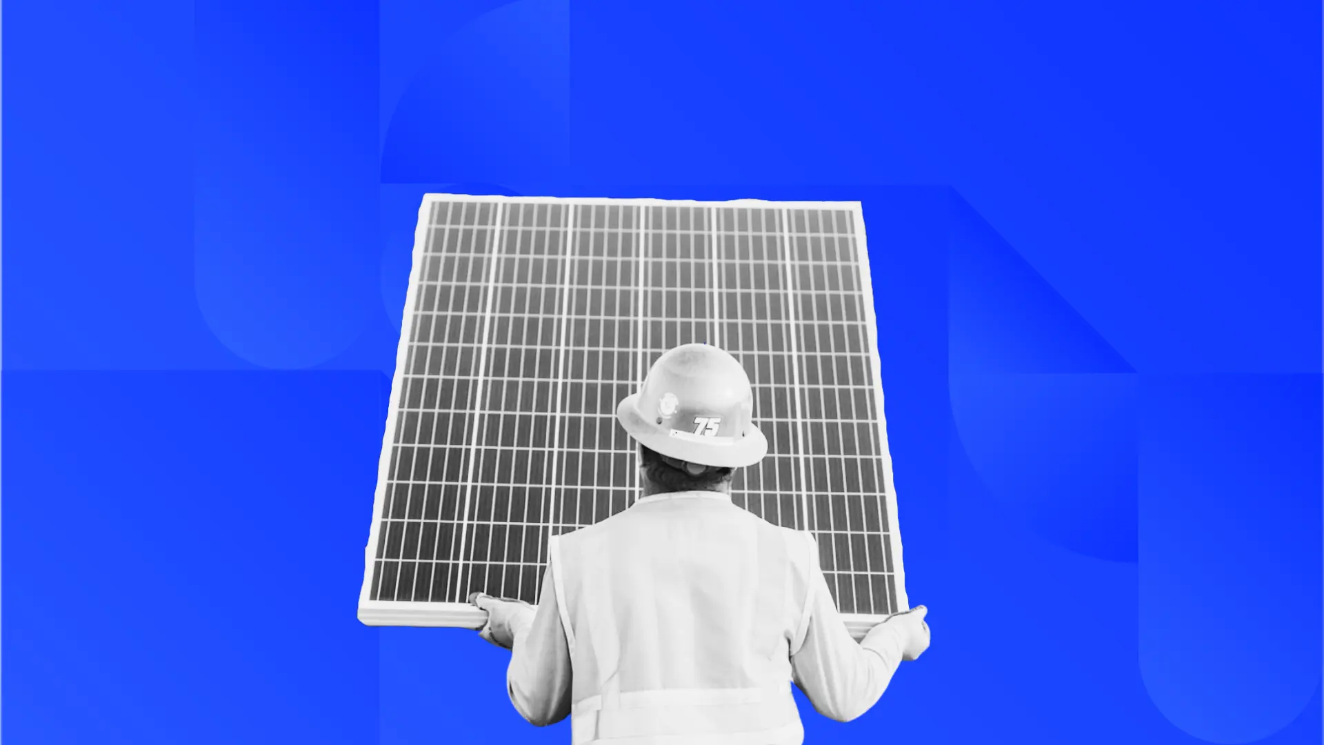 Man in construction gear holding a solar panel