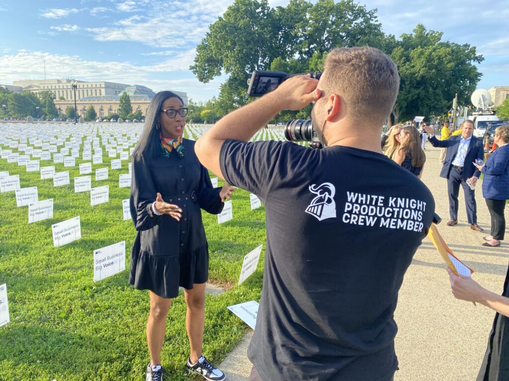 White Knight crew member filming a woman at Capitol Hill.