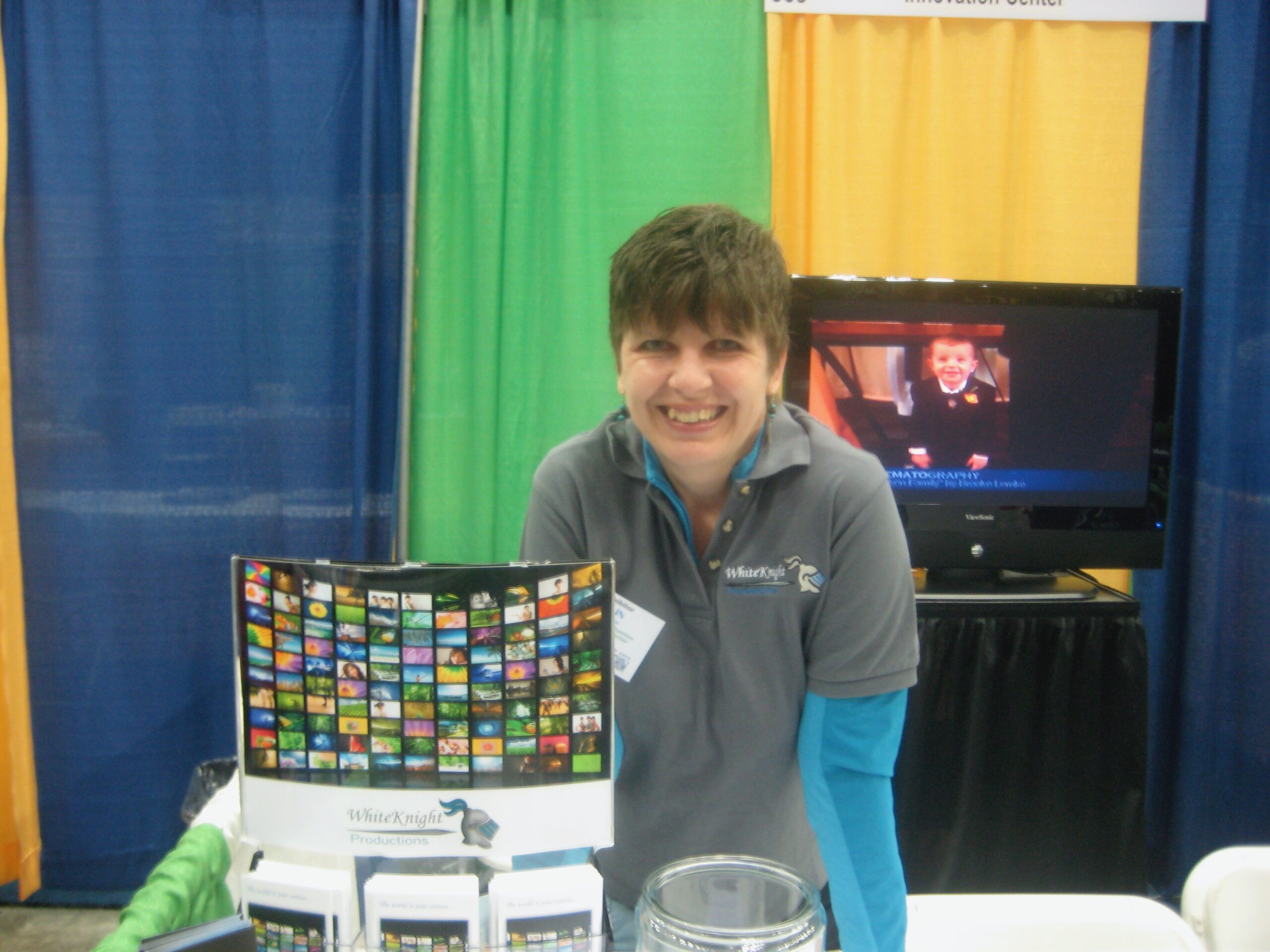 Elin Barton attending a trade show with a booth for White Knight Productions.