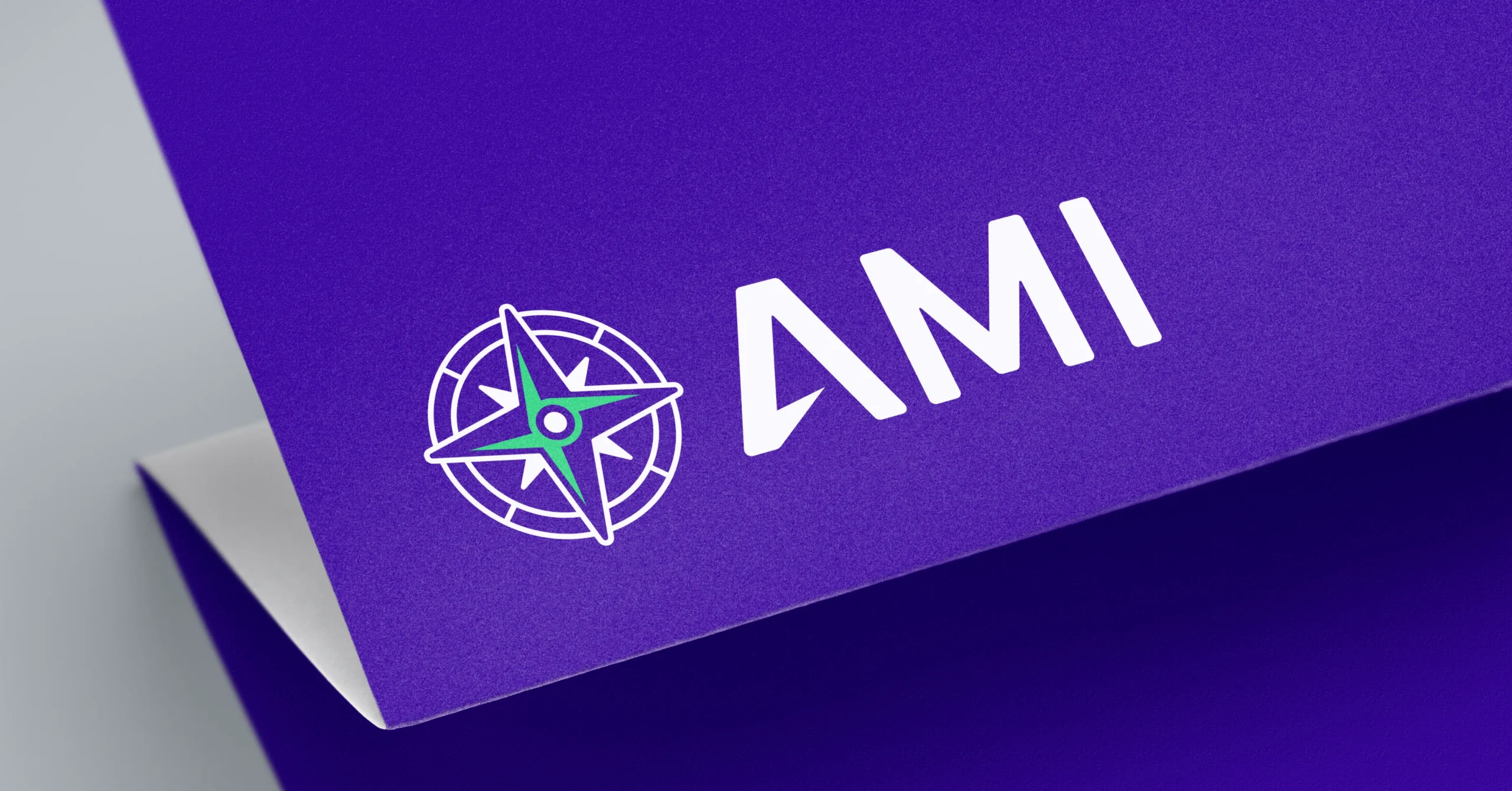 A mockup showing a modern logo design with a compass image and custom letterforms.