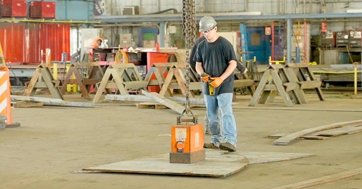 An employee operates machinery in a manufacturing facility.