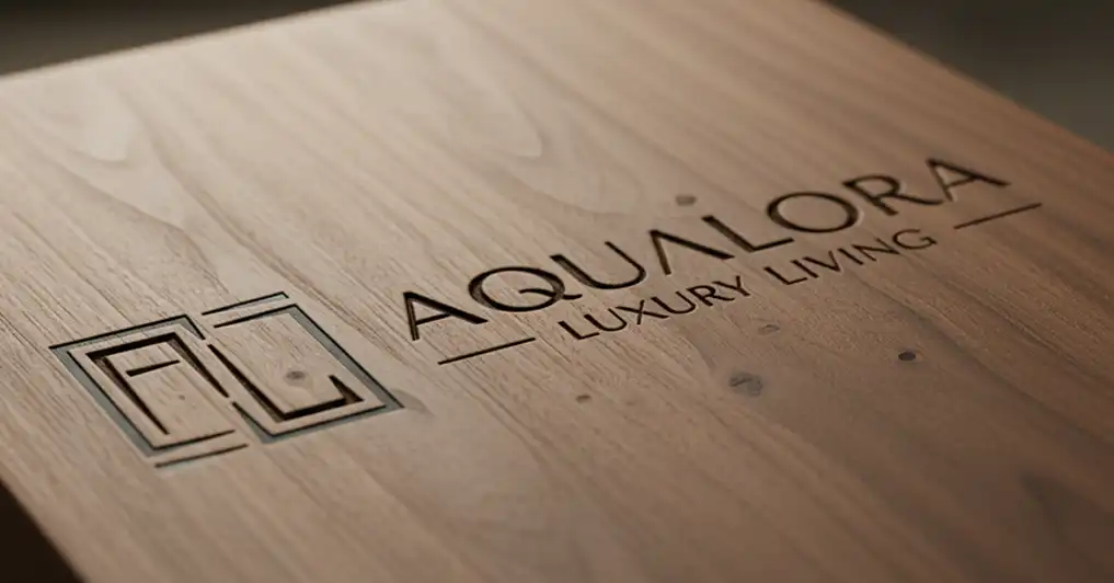 A mockup showing a luxurious logo design carved into a block of wood.